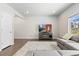 Bright living room with hardwood floors, a plush gray sofa, and a large flat-screen TV for entertainment at 42741 Ivydel Cir, Elizabeth, CO 80107