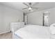 Bright main bedroom boasts a large bed, soft carpet, a ceiling fan and natural light at 42741 Ivydel Cir, Elizabeth, CO 80107
