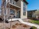 Modern two-story home with a covered porch, stone facade and meticulously maintained landscaping at 6054 N Perth St, Aurora, CO 80019