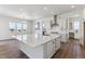 Spacious kitchen boasts a large island, modern appliances, and white cabinetry at 4993 Hickory Oaks St, Castle Rock, CO 80104