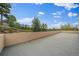 A serene outdoor balcony with sweeping views of lush greenery and the mountains against a vibrant blue sky at 31270 John Wallace Rd # 310, Evergreen, CO 80439