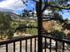 A balcony view framing a scenic mountain landscape, blending nature with urban living at 31270 John Wallace Rd # 310, Evergreen, CO 80439