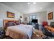 Bright bedroom featuring neutral decor, with a large window showcasing scenic views and natural light at 31270 John Wallace Rd # 310, Evergreen, CO 80439