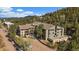 An exterior view of the home surrounded by nature and trees under a blue sky at 31270 John Wallace Rd # 310, Evergreen, CO 80439