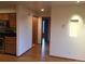 Hallway view adjacent to the kitchen area showcasing hardwood floors and neutral wall colors at 31270 John Wallace Rd # 310, Evergreen, CO 80439