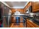 A well-equipped kitchen featuring stainless steel appliances, wooden cabinets, and hardwood floors at 31270 John Wallace Rd # 310, Evergreen, CO 80439