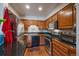 Cozy kitchen with stainless steel appliances, wood cabinets, and stylish black countertops at 31270 John Wallace Rd # 310, Evergreen, CO 80439