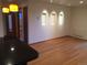 An interior shot of a vacant living room with hardwood floors and recessed lighting at 31270 John Wallace Rd # 310, Evergreen, CO 80439