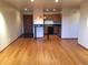 Open-concept living space with hardwood floors, leading into the kitchen area at 31270 John Wallace Rd # 310, Evergreen, CO 80439