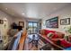 A warm, inviting living space with wood floors, recessed lights, and a sliding door to a balcony at 31270 John Wallace Rd # 310, Evergreen, CO 80439