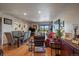 A warm, inviting living space with wood floors, recessed lights, and a sliding door to a balcony at 31270 John Wallace Rd # 310, Evergreen, CO 80439