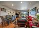 A warm, inviting living space with wood floors, recessed lights, and a sliding door to a balcony at 31270 John Wallace Rd # 310, Evergreen, CO 80439