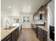 Open concept kitchen featuring dark cabinetry and hardwood floors at 14411 Pansy Loop, Morrison, CO 80465