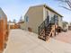 Backyard featuring a concrete patio, deck access, lawn, and wooden fence at 4182 S Bahama St, Aurora, CO 80013