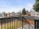 View of fenced backyard and deck access with stairs from the exterior of the property at 4182 S Bahama St, Aurora, CO 80013