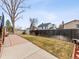 Spacious backyard with a concrete patio, green grass, and a wooden fence providing privacy at 4182 S Bahama St, Aurora, CO 80013
