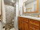 Cozy bathroom with patterned shower curtain, tile floor, and wooden vanity at 4182 S Bahama St, Aurora, CO 80013