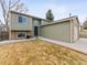 Exterior shot of the home showing a two-car garage, lawn, and steps to the front door at 4182 S Bahama St, Aurora, CO 80013