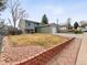 Charming two-story home with attached garage, a well-kept lawn, and red rock landscaping accents at 4182 S Bahama St, Aurora, CO 80013