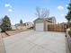 A house with a large driveway leading to an attached two-car garage, and side yard with wood fence at 4182 S Bahama St, Aurora, CO 80013