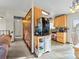 Cozy kitchen featuring light wood cabinets and tiled floors, with a refrigerator on a small rolling island at 4182 S Bahama St, Aurora, CO 80013