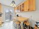 Bright kitchen nook featuring light wood cabinets, tile floors, chandelier, and a sliding door to the backyard at 4182 S Bahama St, Aurora, CO 80013
