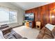 Comfortable living area features wood accent wall, large window, and plush seating at 4182 S Bahama St, Aurora, CO 80013