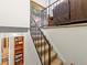 Carpeted stairway with metal railing leading to an upper level with patterned wall art at 4182 S Bahama St, Aurora, CO 80013