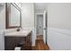 Bathroom with dark brown vanity and a large mirror at 7636 S Eaton Way, Littleton, CO 80128