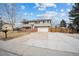 House exterior with driveway, landscaping, and basketball hoop at 7636 S Eaton Way, Littleton, CO 80128