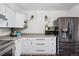 White kitchen with stainless steel appliances and microwave at 7636 S Eaton Way, Littleton, CO 80128