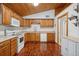 Bright kitchen with wood cabinets, stainless steel appliances, and wood-look flooring at 7636 S Eaton Way, Littleton, CO 80128