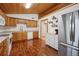 Bright kitchen with wood cabinets, stainless steel appliances, and wood-look flooring at 7636 S Eaton Way, Littleton, CO 80128