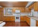 Bright kitchen with wood cabinets, modern appliances, and wood flooring at 7636 S Eaton Way, Littleton, CO 80128