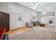 Bright living room with a sliding barn door, hardwood floors, and large windows at 7636 S Eaton Way, Littleton, CO 80128