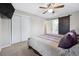 Main bedroom with a king-size bed, ceiling fan, and sliding barn door to the bathroom at 7636 S Eaton Way, Littleton, CO 80128