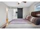 Main bedroom with a king-size bed and access to the bathroom through a sliding barn door at 7636 S Eaton Way, Littleton, CO 80128