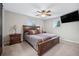 Main bedroom with a king-size bed, a large TV, and double door closet at 7636 S Eaton Way, Littleton, CO 80128