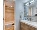 Bathroom featuring a modern vanity with a wooden cabinet and a shower with light tile at 5300 E Cherry Creek South Dr # 804, Denver, CO 80246