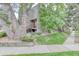 Exterior view of the building shows large trees and manicured lawn at 5300 E Cherry Creek South Dr # 804, Denver, CO 80246