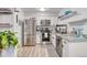 Bright kitchen features stainless steel appliances, gray granite countertops, and modern white cabinetry at 5300 E Cherry Creek South Dr # 804, Denver, CO 80246