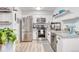 Bright kitchen features stainless steel appliances, gray granite countertops, and modern white cabinetry at 5300 E Cherry Creek South Dr # 804, Denver, CO 80246