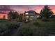 Exterior rear view of home featuring a patio at sunset at 5855 Saddle Creek Trl, Parker, CO 80134