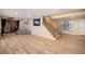 Finished basement featuring wood flooring, and staircase with metal railing at 5855 Saddle Creek Trl, Parker, CO 80134