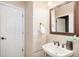 Cozy bathroom with decorative mirror, patterned tile and vanity at 5855 Saddle Creek Trl, Parker, CO 80134