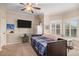 Bedroom with plantation shutters, blue bedding, and desk area at 5855 Saddle Creek Trl, Parker, CO 80134