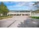 Exterior of building with brick-paved entry, architectural columns, and verdant landscaping at 5855 Saddle Creek Trl, Parker, CO 80134