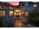 A well-lit front exterior of a home with a large front door and meticulous landscaping at 5855 Saddle Creek Trl, Parker, CO 80134