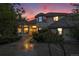 Stately home with a circular driveway, mature landscaping illuminated by a sunset at 5855 Saddle Creek Trl, Parker, CO 80134