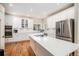 Spacious kitchen with modern appliances, hardwood floors, and a large center island at 5855 Saddle Creek Trl, Parker, CO 80134